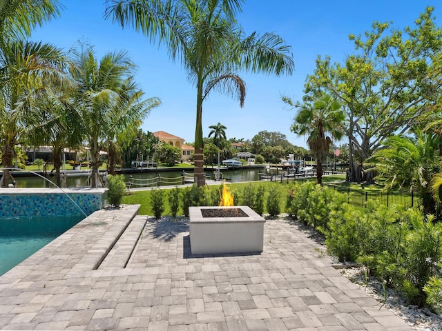 view of patio with a water view and a fire pit