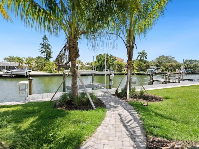 dock area with a water view and a yard