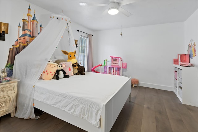 bedroom with dark hardwood / wood-style flooring and ceiling fan