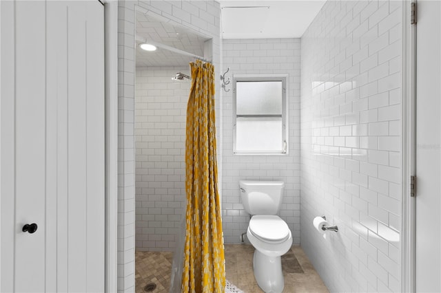 bathroom featuring toilet, tile walls, tile patterned floors, and walk in shower