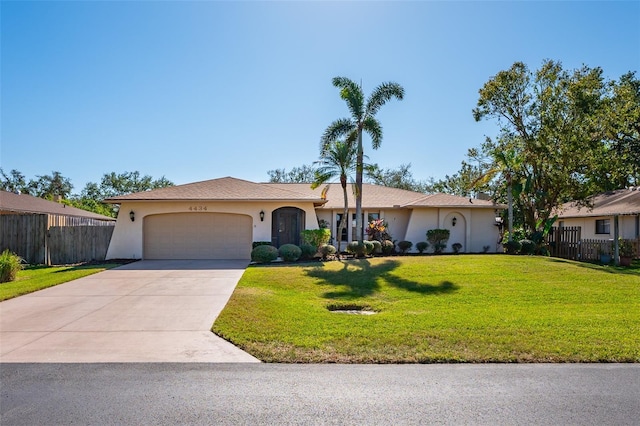 ranch-style home featuring a garage and a front lawn