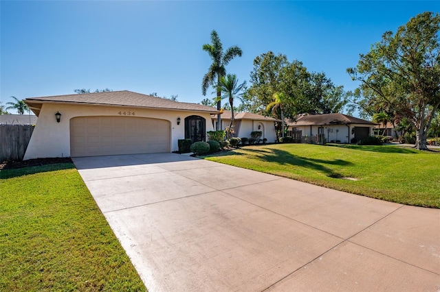 ranch-style home with a front yard and a garage