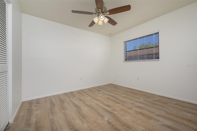 unfurnished room with ceiling fan, light hardwood / wood-style floors, and a textured ceiling