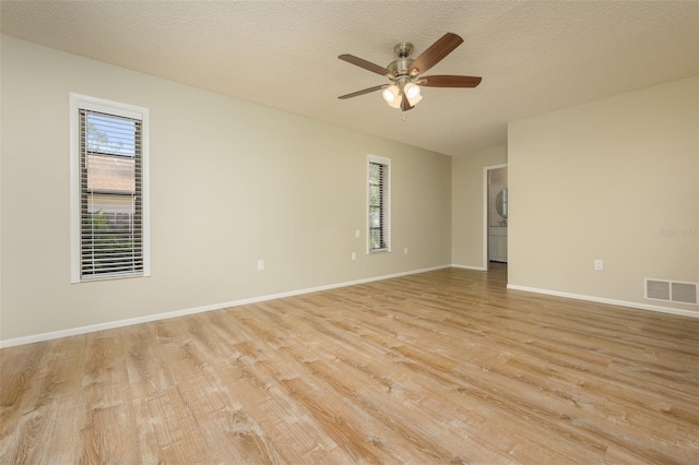 spare room featuring ceiling fan, a textured ceiling, and light wood-type flooring