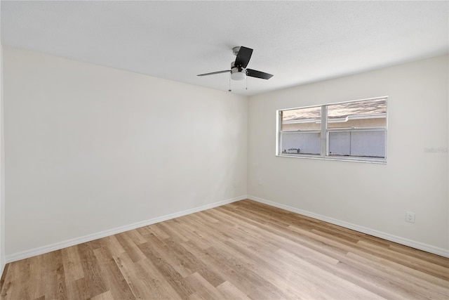 empty room featuring light hardwood / wood-style floors and ceiling fan