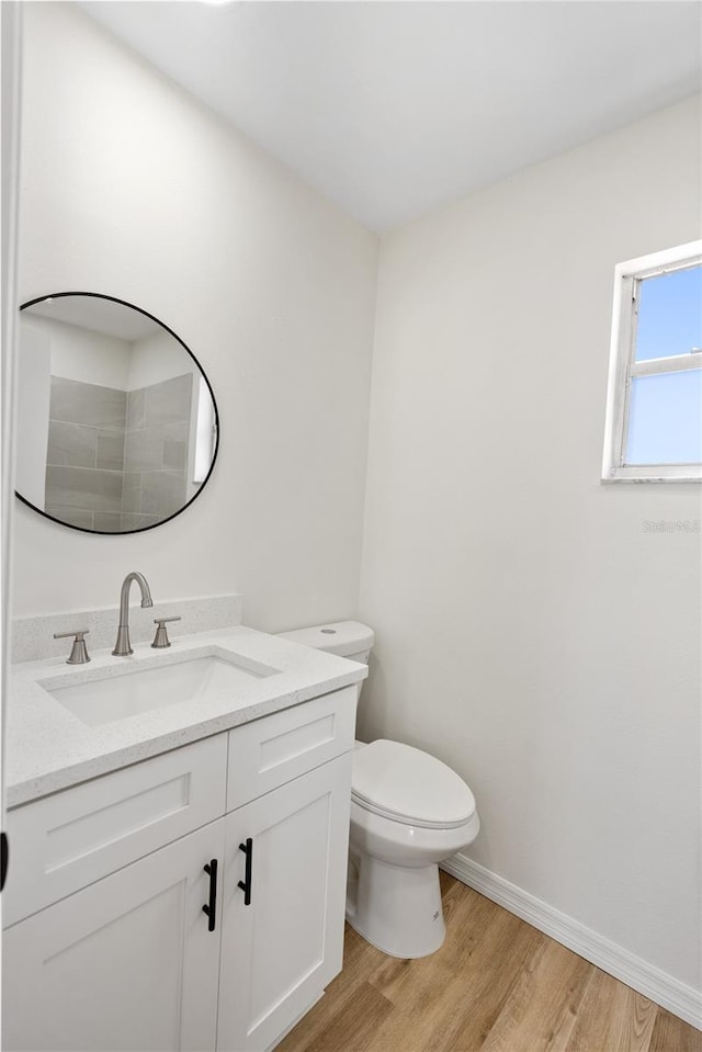 bathroom featuring hardwood / wood-style floors, vanity, and toilet