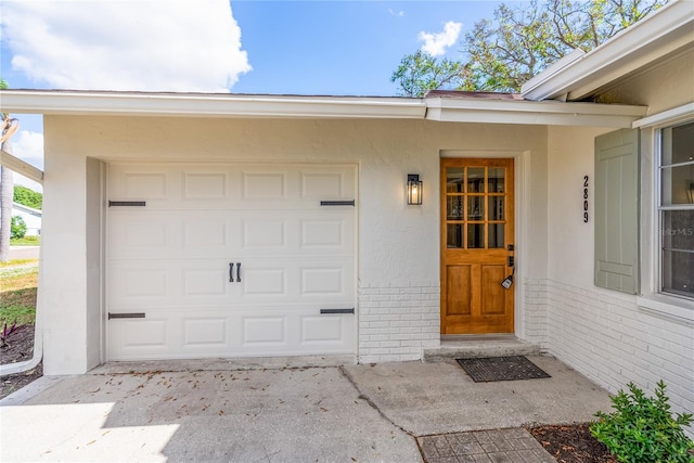 doorway to property with a garage