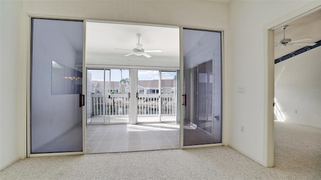 doorway with french doors, ceiling fan, and carpet floors