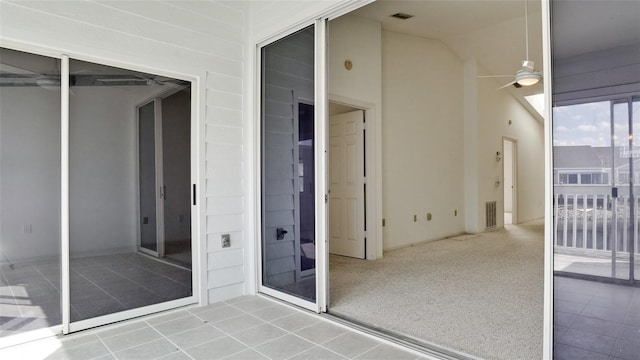 interior space with ceiling fan and a balcony