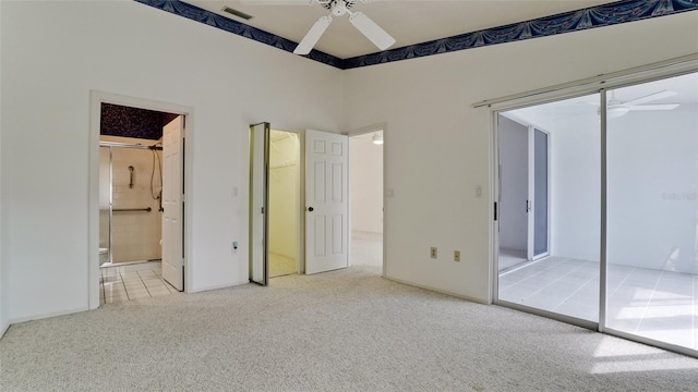 unfurnished bedroom featuring ceiling fan, ensuite bath, and light colored carpet