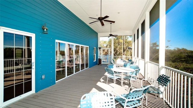 unfurnished sunroom featuring ceiling fan