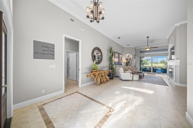 living room featuring light tile patterned floors, visible vents, baseboards, and crown molding