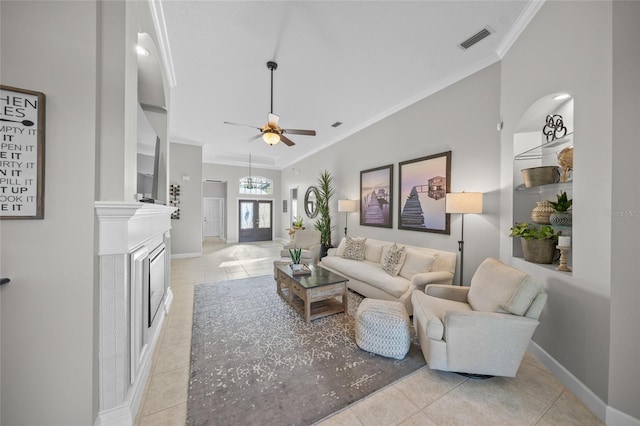 living area with crown molding, visible vents, light tile patterned flooring, ceiling fan, and baseboards