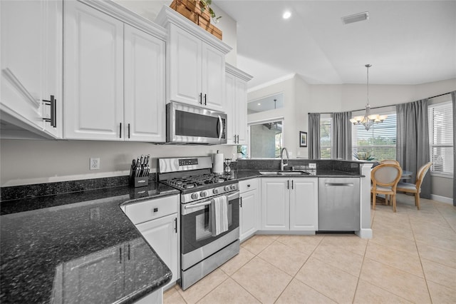 kitchen with appliances with stainless steel finishes, white cabinets, a sink, and visible vents