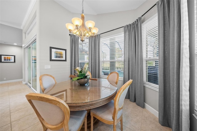 dining space featuring baseboards, a chandelier, and light tile patterned flooring