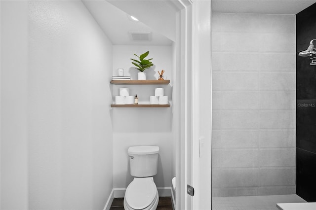 full bath with baseboards, visible vents, and toilet