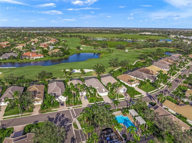 birds eye view of property with golf course view, a water view, and a residential view