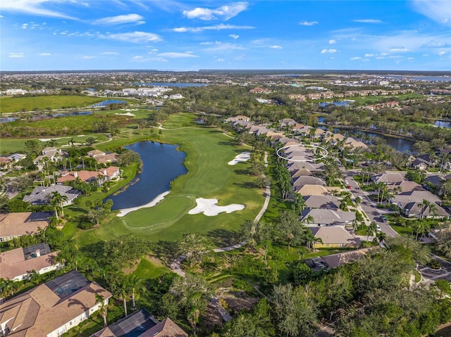 birds eye view of property featuring golf course view, a water view, and a residential view