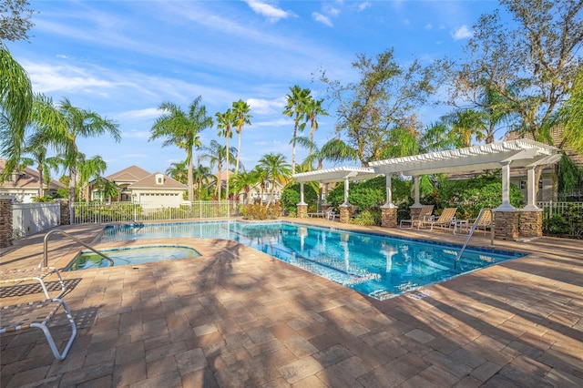 community pool featuring a patio area, a hot tub, fence, and a pergola