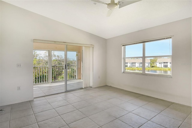 unfurnished room with light tile patterned flooring, vaulted ceiling, and ceiling fan