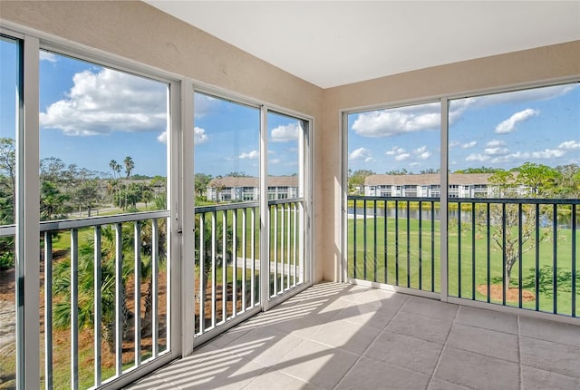 unfurnished sunroom with a water view