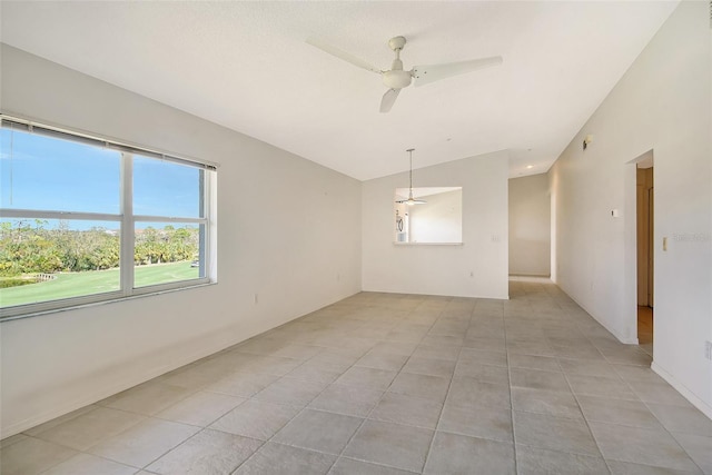 tiled spare room featuring ceiling fan and lofted ceiling