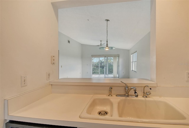 kitchen featuring lofted ceiling and sink