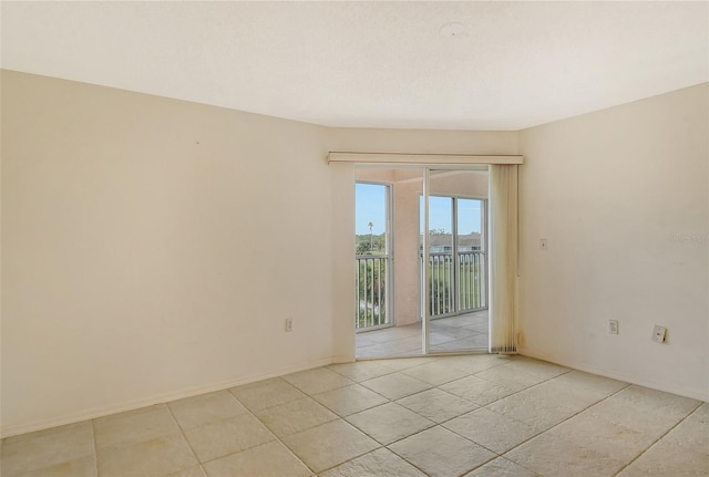 spare room featuring light tile patterned floors