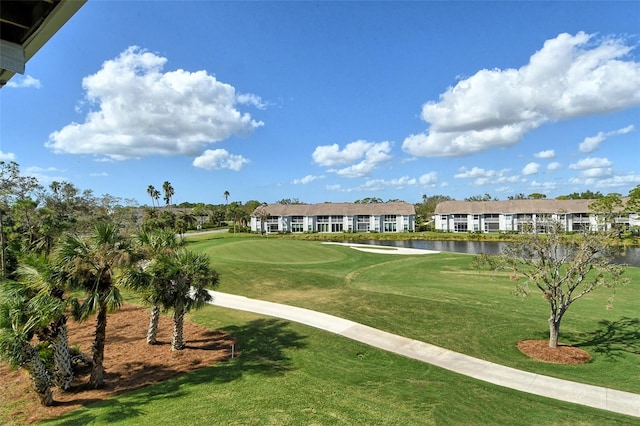 view of home's community featuring a lawn and a water view