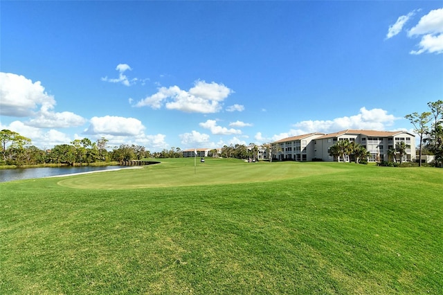 view of community with a water view and a lawn