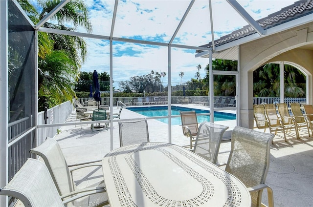 view of swimming pool with a lanai and a patio