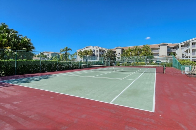 view of tennis court with basketball hoop