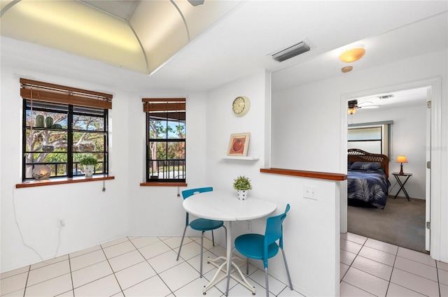 tiled dining area with ceiling fan