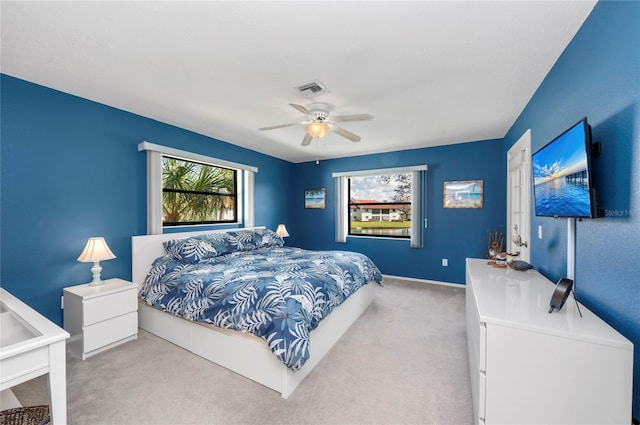 bedroom featuring light colored carpet and ceiling fan