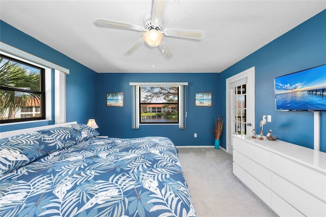 bedroom featuring light colored carpet and ceiling fan