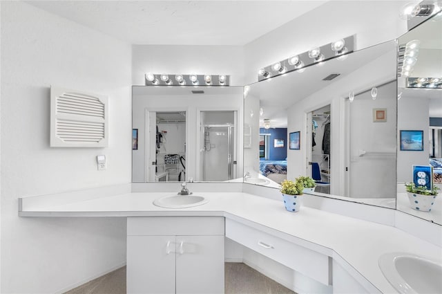 bathroom featuring an enclosed shower and vanity