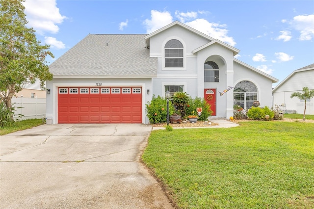 front facade with a front lawn and a garage