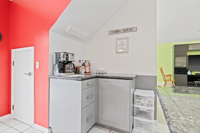 kitchen with light tile patterned floors and high vaulted ceiling