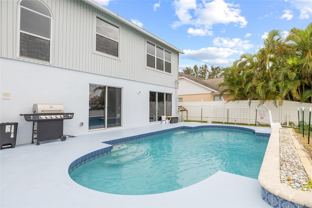 view of pool featuring a patio and grilling area