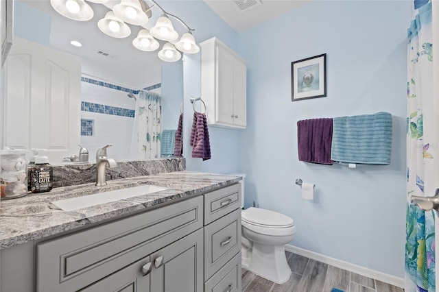 bathroom featuring hardwood / wood-style flooring, vanity, curtained shower, and toilet