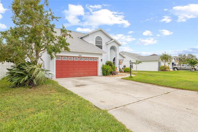 view of front facade with a garage and a front yard