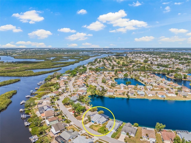 birds eye view of property featuring a water view and a residential view