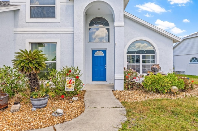 property entrance featuring stucco siding
