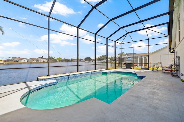 outdoor pool with glass enclosure, a water view, and a patio area