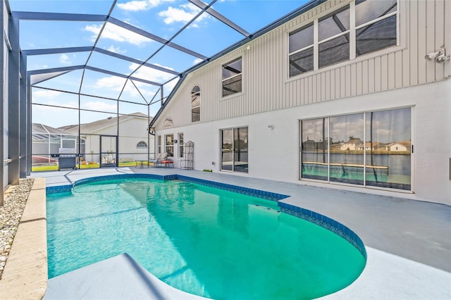 outdoor pool with a lanai and a patio area