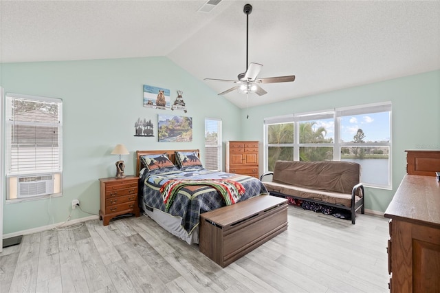 bedroom featuring cooling unit, lofted ceiling, ceiling fan, light wood-style flooring, and visible vents