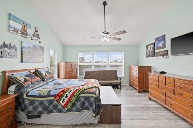 bedroom with lofted ceiling, ceiling fan, and light wood-type flooring