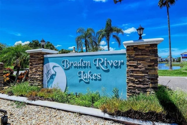 community sign with a water view