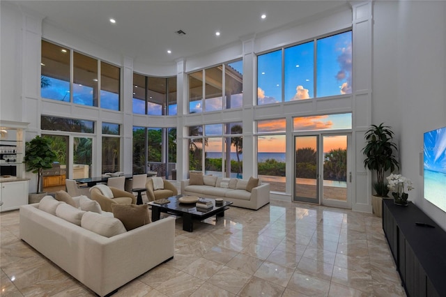 living room with a wealth of natural light and a towering ceiling