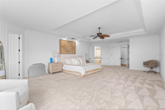 bedroom featuring a tray ceiling, ceiling fan, and light colored carpet